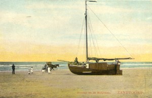 A boat on Zandvoort beach with children playing nearby